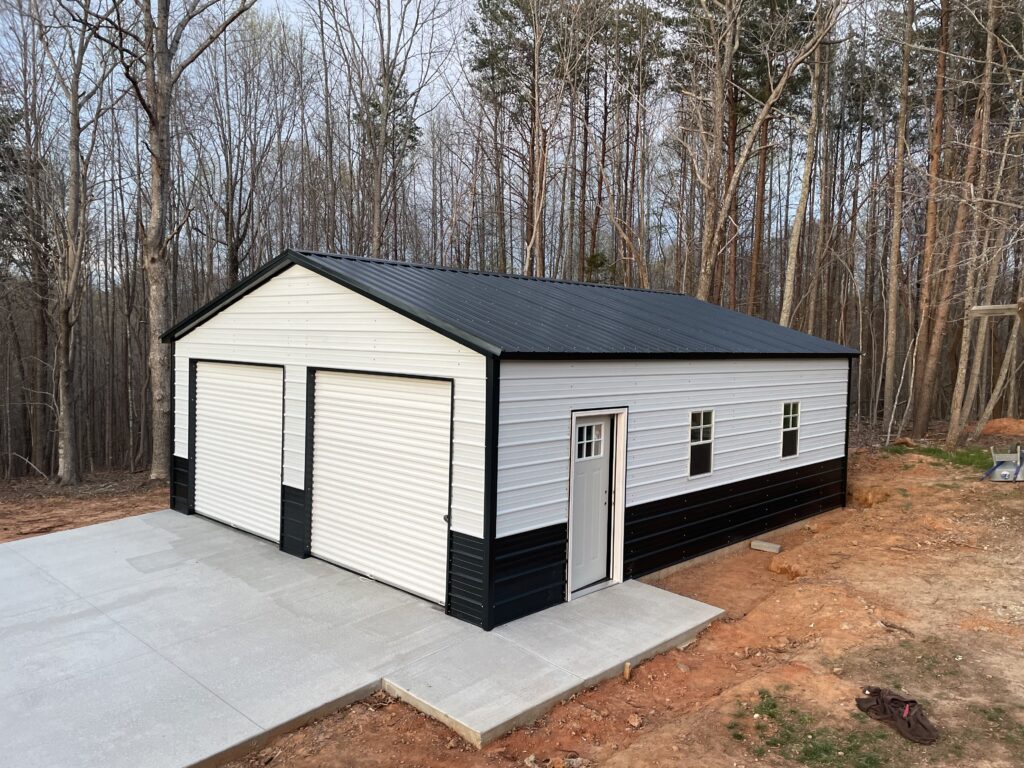 https://www.newmartbuildersinc.com/wp-content/uploads/2023/05/24X26X9-TWO-TONED-VERTICAL-ROOF-GARAGE-1024x768.jpg