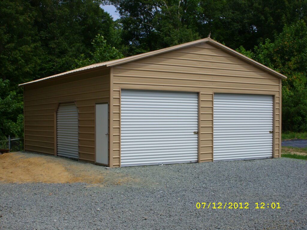 Photo of A Frame Garage with 2 rollup doors in the gable end, and a roll up door on the side with one walk in door Item #43